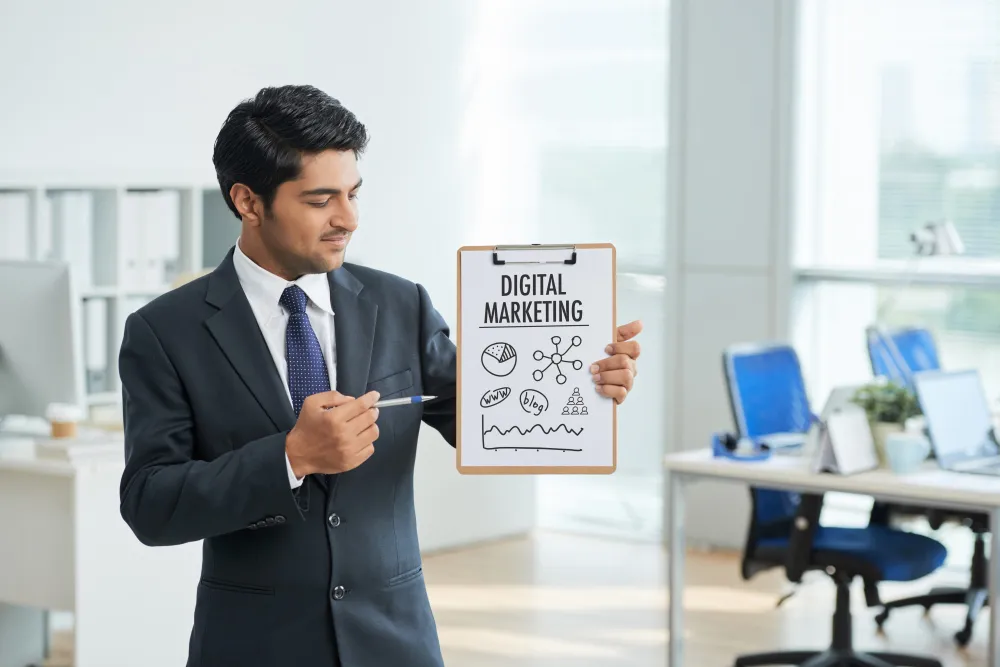 a guy with tidy suit pointing at digital marketing binder with a pen